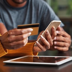 Woman using a card payment option on her cell phone